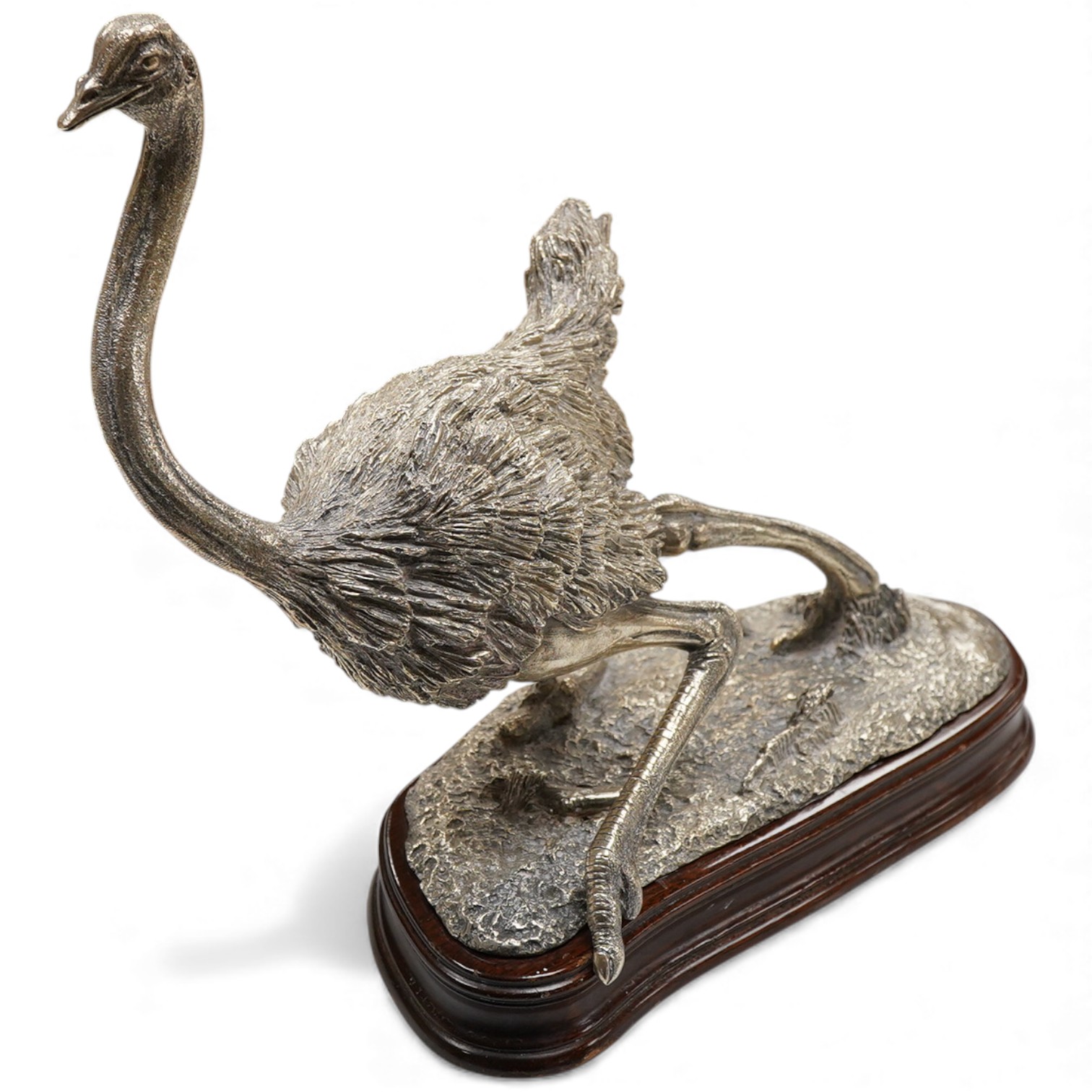 After Tim Nicklin(Kenyan) - A 1980's limited edition silver model of a running ostrich, by Roger John Squires, London, 1986, inscribed 'Tim Nicklin 2/10 1985', on a naturalistic base, fixed to a shaped oval wooden base,